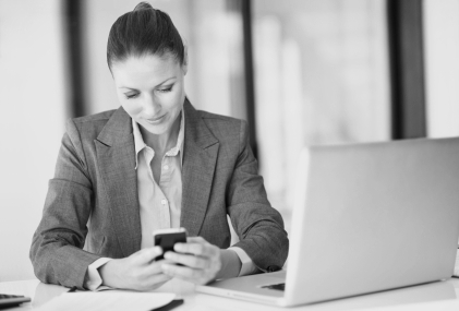 Business woman text messaging in office